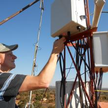 David installing a VillageCell base station in Macha. 2012